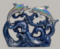 Example finished resin pour: holographic dolphins above navy glitter waves on a neutral background.