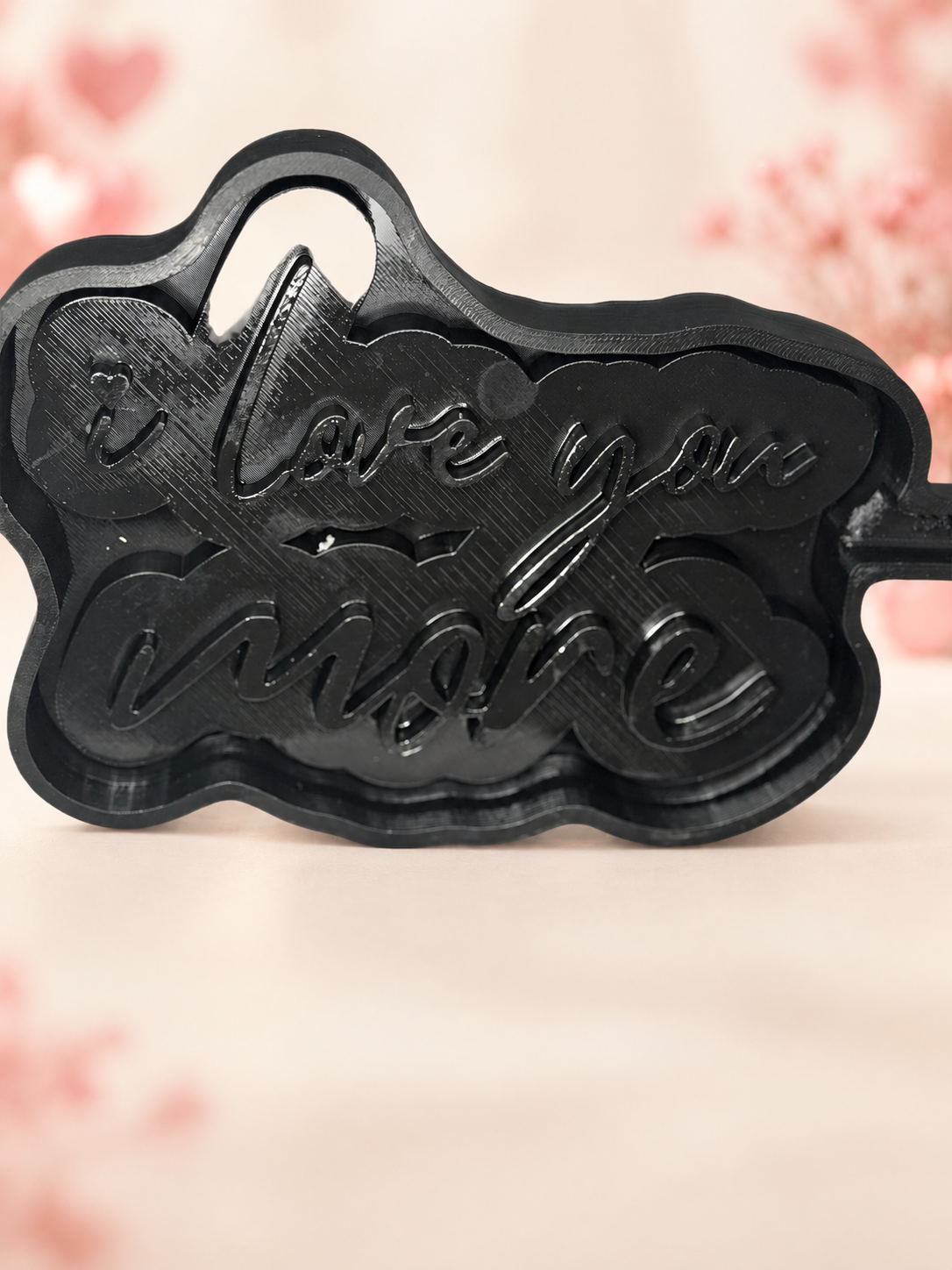 “I Love You More” Sign Mold on a subtle Valentine's Day background